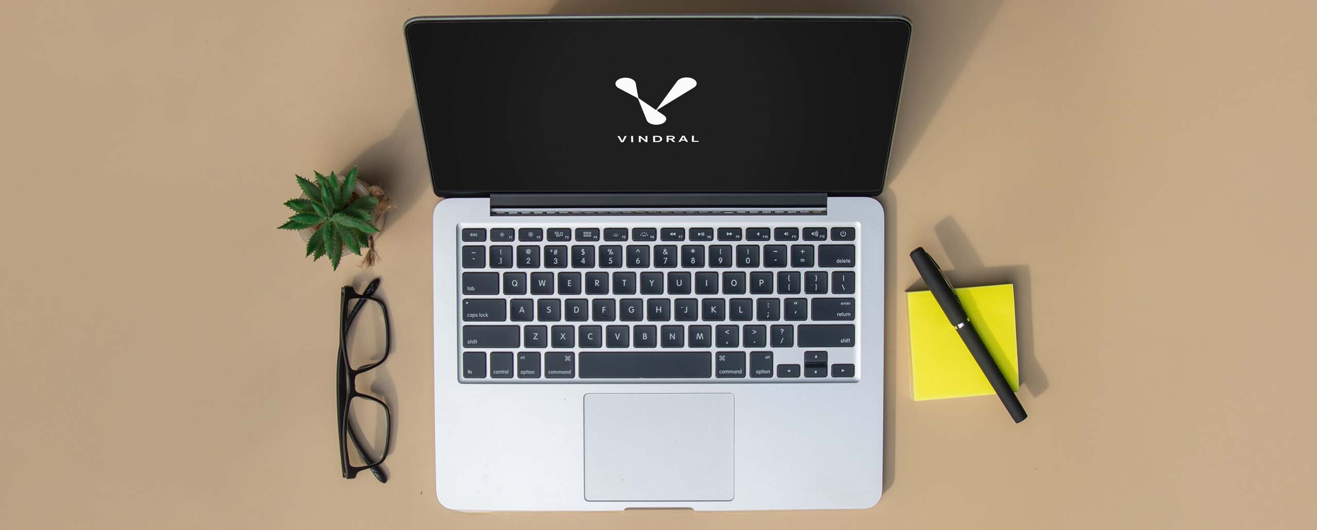 Desk with glasses and a laptop