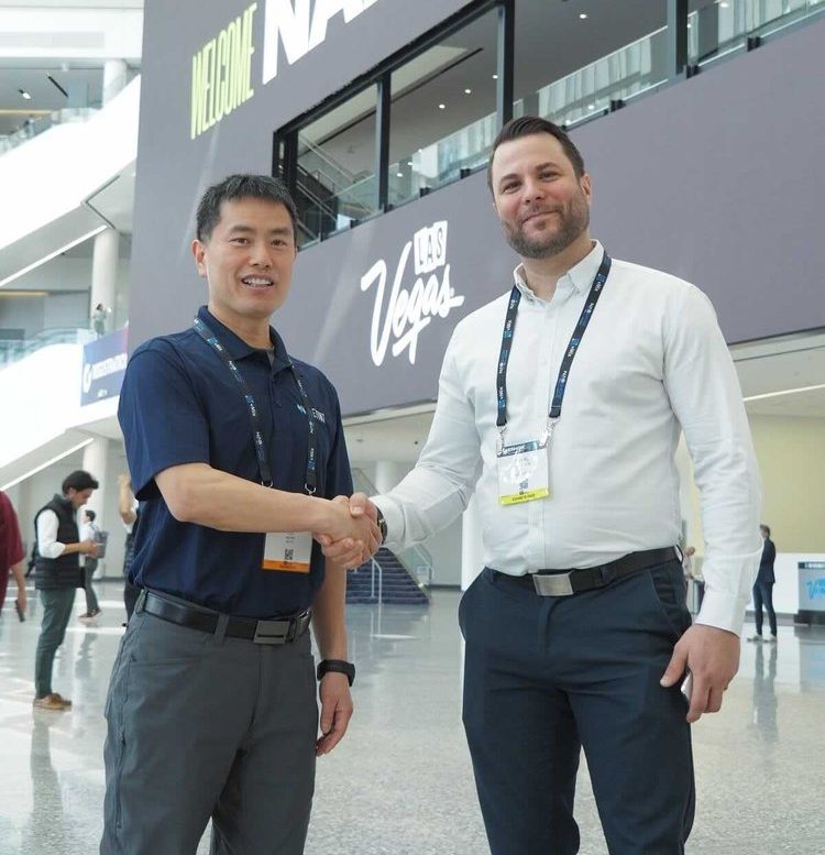 CEO Daniel shaking hands with rep from Netint
